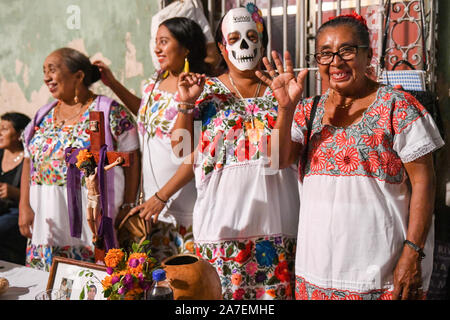 Women in front of their family altar during Hanal Pixan which is the celebration of the Day of the Dead that originated from Mayan culture. Merida, Yucatan, Mexico Stock Photo