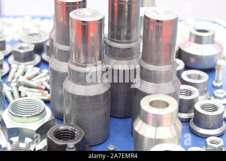 small bolts and nuts by manufacturing process ; tapping ; metallurgy engineering industrial background Stock Photo