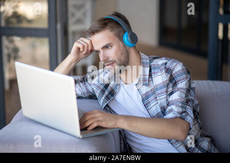 Bearded freelancer feeling overloaded having too much tasks Stock Photo