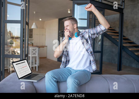 Businessman yawning while feeling sleepy after work Stock Photo