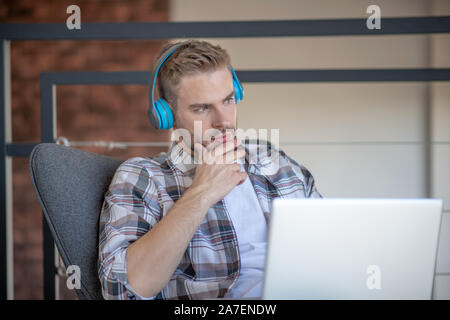 Bearded freelancer feeling thoughtful while starting new project Stock Photo