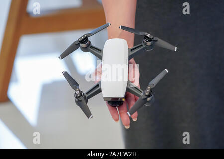 mini Drone on the woman hand in gadget store Stock Photo
