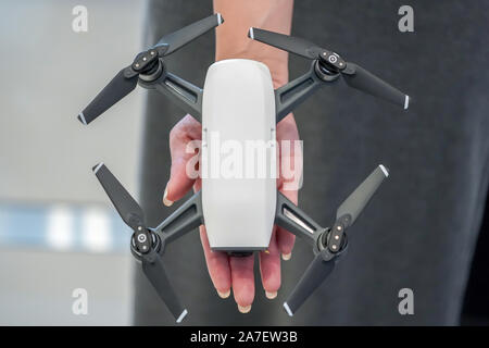 mini Drone on the woman hand in gadget store Stock Photo