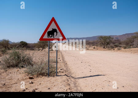 Elephant Crossing Road Warning Sign in Namibia, Triangle Shape, Danger of Animal Collisions Attention Sign Stock Photo