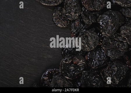 food background texture of prunes close-up on black Stock Photo