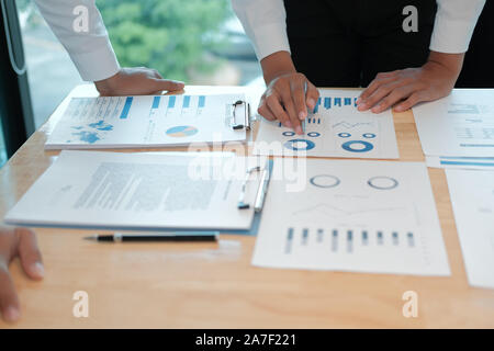 financial adviser analyzing performance revenue with investor. business people discussing in meeting. businessman working with co-worker team. Stock Photo