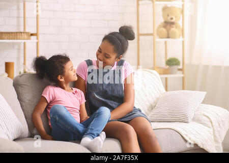 Happy african girls spending weekend together at home Stock Photo