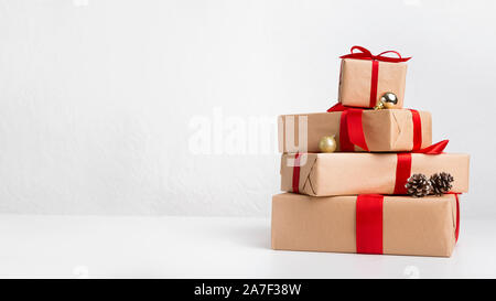 Christmas gift boxes laid out in shape of pine tree on white Stock Photo