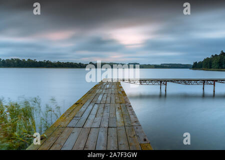 Ilawa Lake District. Platform at Orkusz Lake during Sunrise Stock Photo