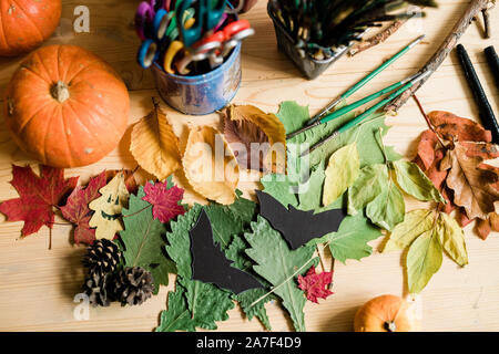 Autumn background with dry colorful leaves, pumpkins, pinecones, paintbrushes Stock Photo