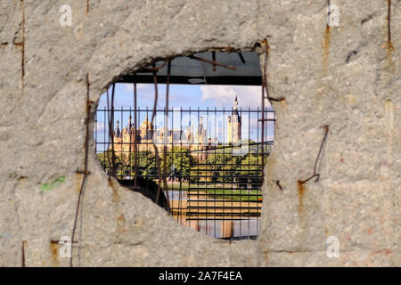 Berlin, Berlin, Germany. 1st Nov, 2019. A tourist bus with an advertising sticker of a romantic castle can be seen through a hole of the remaining 200 meters of the Berlin Wall at NiederkirchnerstraÃŸe in Central Berlin. The Berlin Wall was massive border complex and became an international symbol of the division of Germany after the Second World War and also of the Cold War between East and West. November 9, 2019 will mark the 30th anniversary of the peaceful 'fall'' of the Wall on November 9, 1989. Credit: Jan Scheunert/ZUMA Wire/Alamy Live News Stock Photo