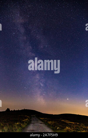 Milky way over the Clwydian Range AONB in North Wales at night Stock Photo