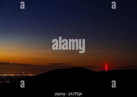 Clwydian range hills at night with stars and Moel y Parc transmitter mast Stock Photo