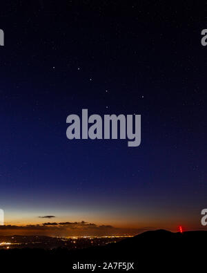 Clwydian range hills at night with stars and Moel y Parc transmitter mast Stock Photo