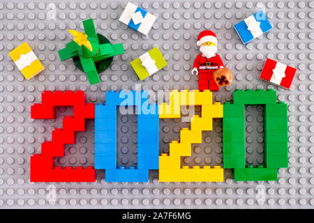 Tambov, Russian Federation - September 28, 2019 Numbers 2020 made by Lego blocks with Christmas tree, Santa Clause with bag and presents on gray basep Stock Photo