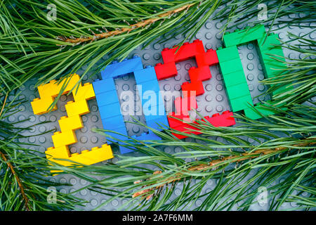 Tambov, Russian Federation - September 28, 2019 Numbers 2020 made by Lego blocks and pine branches on Lego gray baseplate background. Studio shot. Stock Photo