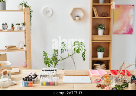 Workplace of soap maker in studio with set of supplies and equipment on table Stock Photo