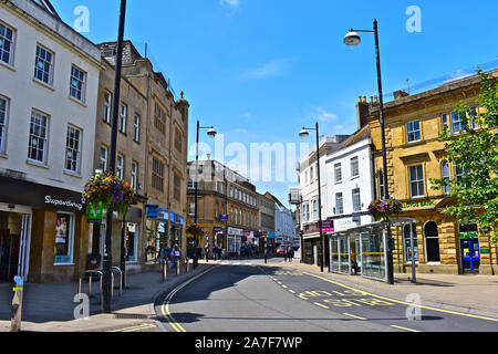 A view of High Street, in the old part of Yeovil with a mixture of banks, shops & cafés. Two jewellers shops with Art Deco style clock wall mounted ab Stock Photo