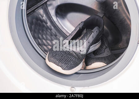 Sneakers inside the washing machine Stock Photo