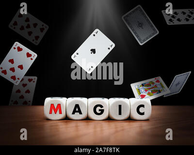 Dice spelling the word magic with flying cards in the background Stock Photo