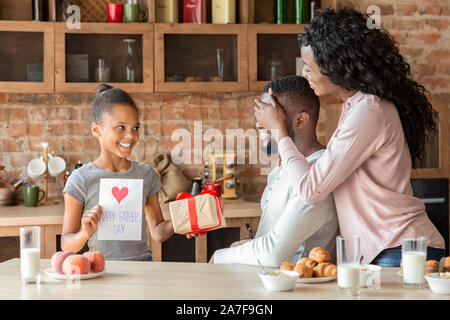 Wife and daughter making surprise to dad on fathers day Stock Photo