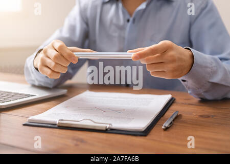 Man holding smartphone in horizontal orientation using scanner app Stock Photo