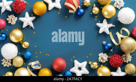 Christmas frame. Flat lay balls, stars, ribbon on blue background. Christmas banner mockup, poster, flyer. Stock Photo