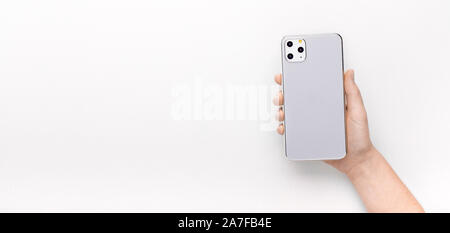Woman holding in hand new 11 IPhone Pro with three cameras Stock Photo