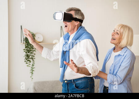 New feelings. Excited mature man using the VR glasses Stock Photo