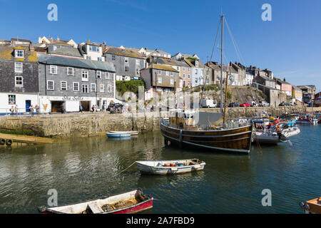 Mevagissey harbour with boats at anchor the village is within the Cornish Area of Outstanding Natural Beauty Stock Photo