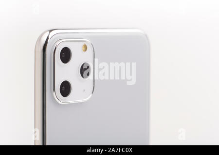 The latest Iphone 11 Pro Max model in silver set with close up of camera review Stock Photo