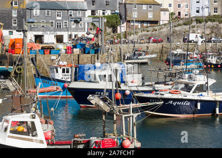 Mevagissey harbour with boats at anchor the village is within the Cornish Area of Outstanding Natural Beauty Stock Photo