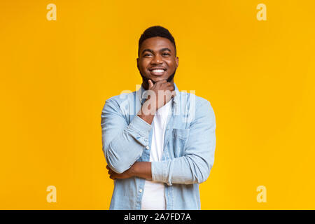Portrait of handsome black guy touching his beard Stock Photo