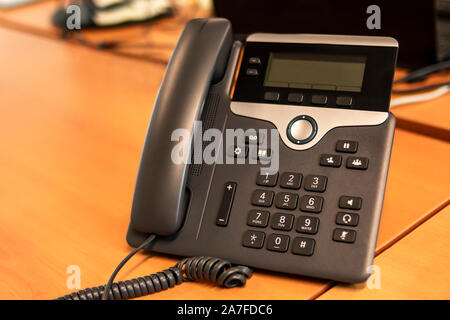 Office IP telephone set with big LCD at office desk Stock Photo