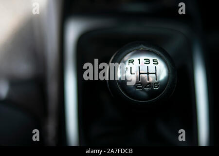 Close up view of a gear lever shift. Manual gearbox. Car interior details. Car transmission. Soft lighting. Abstract view. European car Stock Photo