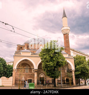 Sofia, Bulgaria - June 24, 2019: The Banya Bashi mosque and people at sunset Stock Photo