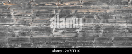 Panorama of old, stacked, gray wooden beams Stock Photo