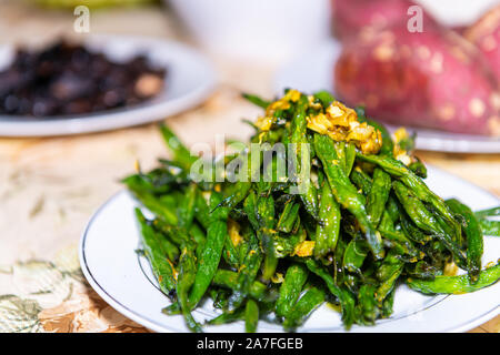 Dehydrated dried vegetables green beans and garlic seasoning raw vegan food on plate for thanksgiving meal on table Stock Photo