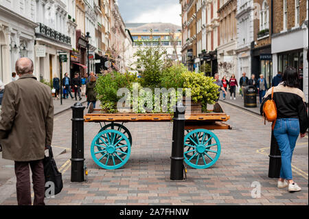 London, UK. 02-05-2019. Covent Garden Market. Flowers and plants on a market wagon display in the square of restored market buildings. Stock Photo