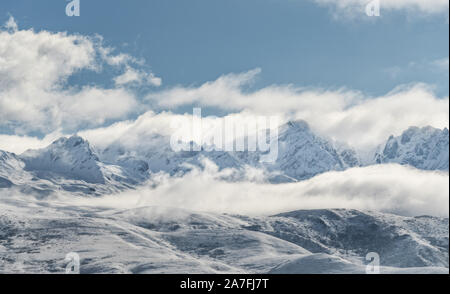 Panoramic snow mountain with white clouds and blue sky Stock Photo