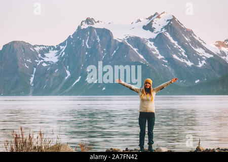 Happy woman hands raised enjoying  mountains landscape travel adventure vacations healthy lifestyle motivation Stock Photo
