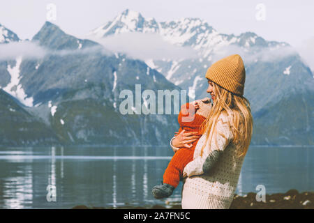 Mother with baby traveling enjoying mountains view family lifestyle mom and child active healthy lifestyle vacations outdoor Stock Photo