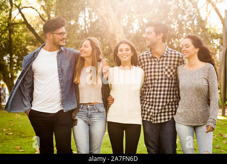 Group of students walking together in the park Stock Photo