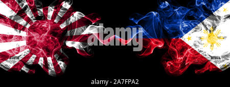 Japan rising sun naval vs Philippines, Filipino smoky mystic states flags placed side by side. Thick colored silky travel abstract smokes banners Stock Photo