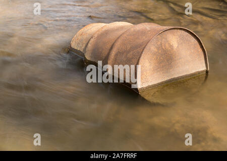 Old Rusty Barrel In A Creek Stock Photo