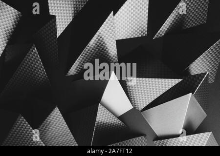 Triangular shapes of paper on dark background, abstract Stock Photo