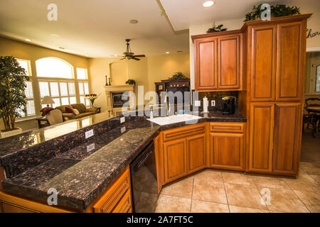 Modern Kitchen With Rich Wood Cabinets & Black Granite Counter Stock Photo