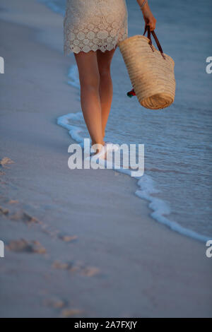 Beach vacation. Closeup on middle aged woman in white blouse and shorts ...