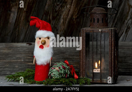 A christmas figure with very rusty and old lantern and textile cone Stock Photo