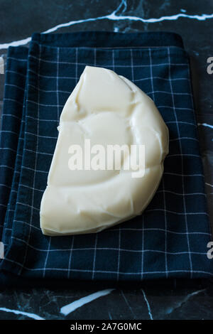 Turkish Cheese Abaza Peyniri on Black Tablecloth. Traditional Organic Food. Stock Photo